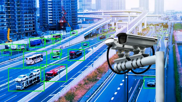 Traffic camera view with vehicles detected and marked by bounding boxes