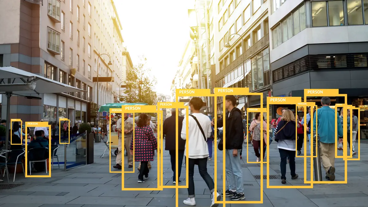 Street scene with bounding boxes around pedestrians
